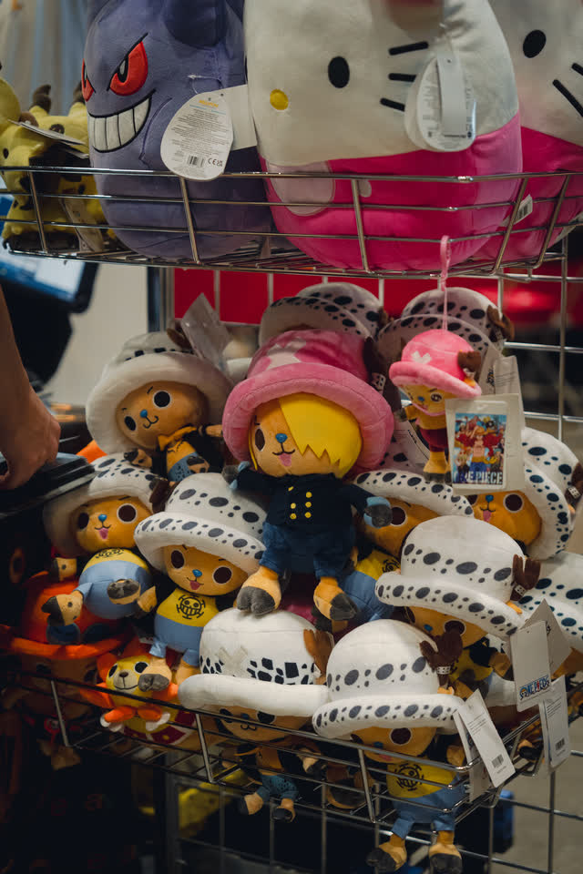 A stand stacked with plush toys and character merchandise.