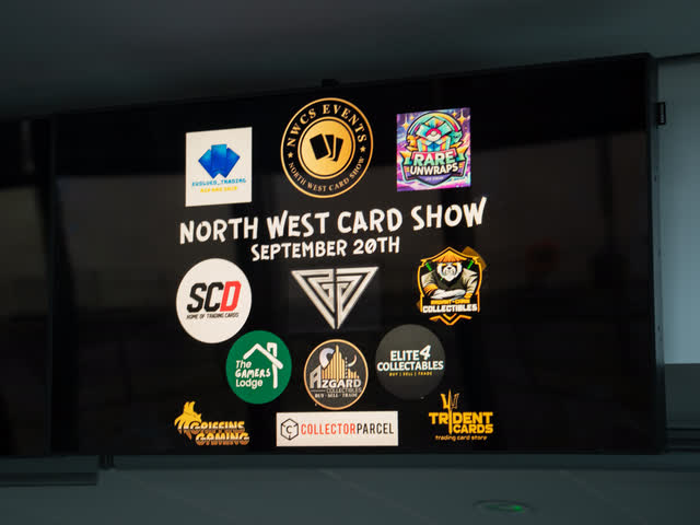 A display screen reading North West Card Show, September 20th, ringed by sponsor logos.