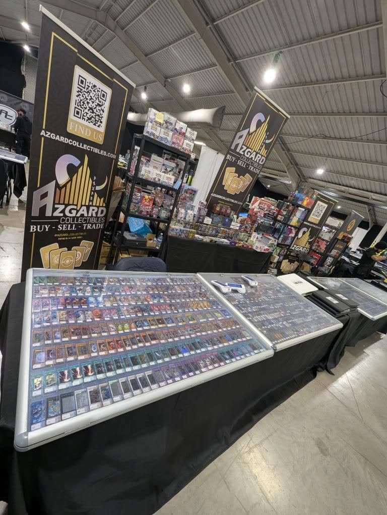 The Azgard Collectibles stand, with banners and a long display case of cards