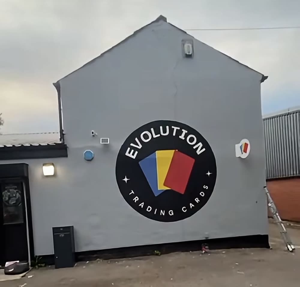 The Evolution Trading Cards logo painted on the side of their building